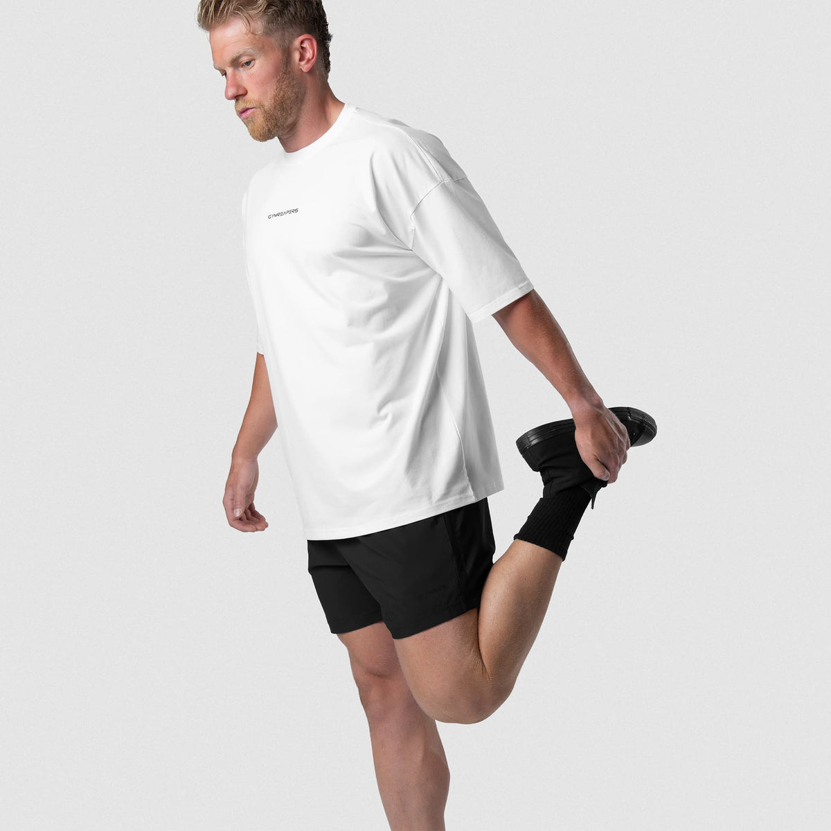 Male model wearing the Axis 6" Lined Shorts - Black/Black movement view