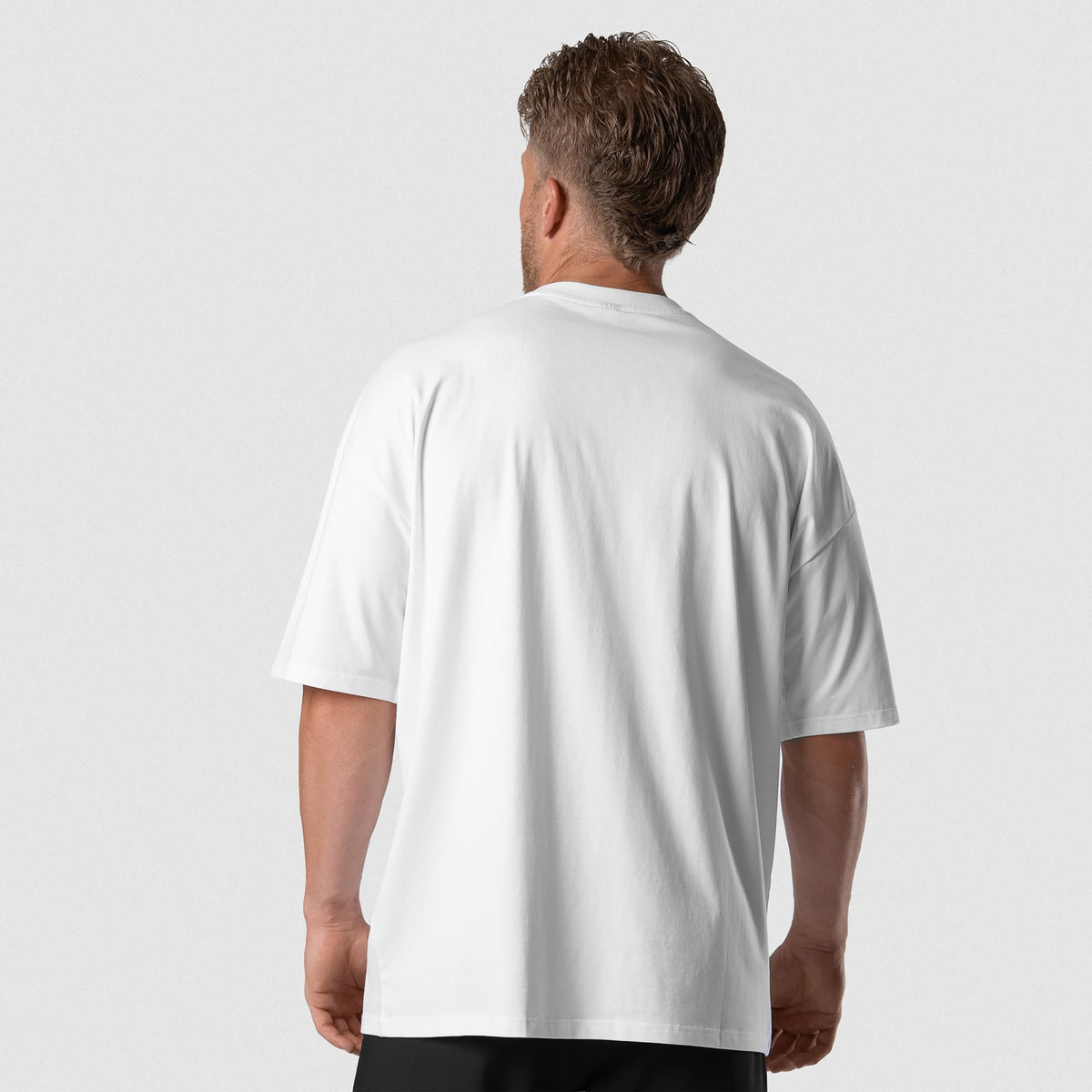 Male model wearing the Axis Box Tee - White back view