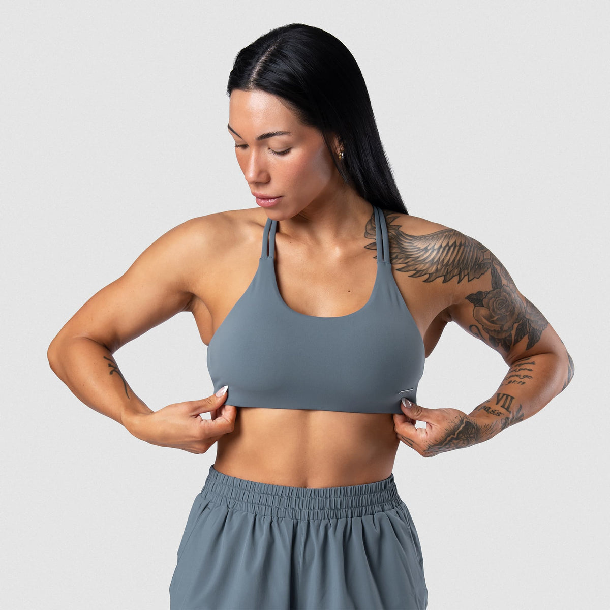 Female model wearing the Axis Open Back Bra - Lake front view