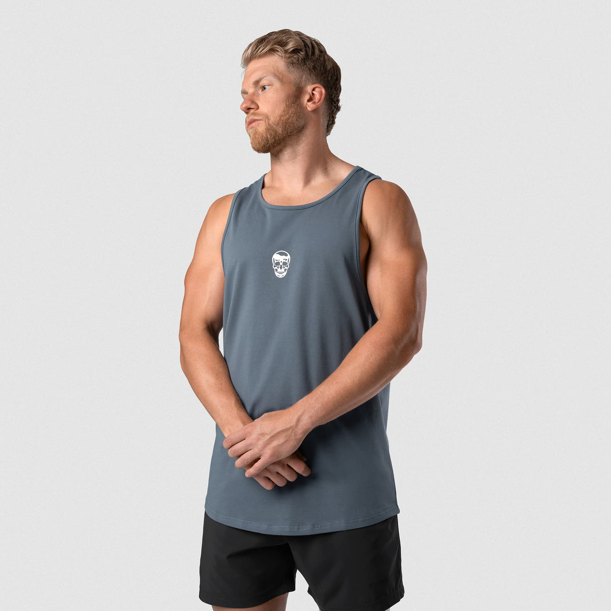 Male model wearing the Axis Scoop Hem Tank - Lake front view