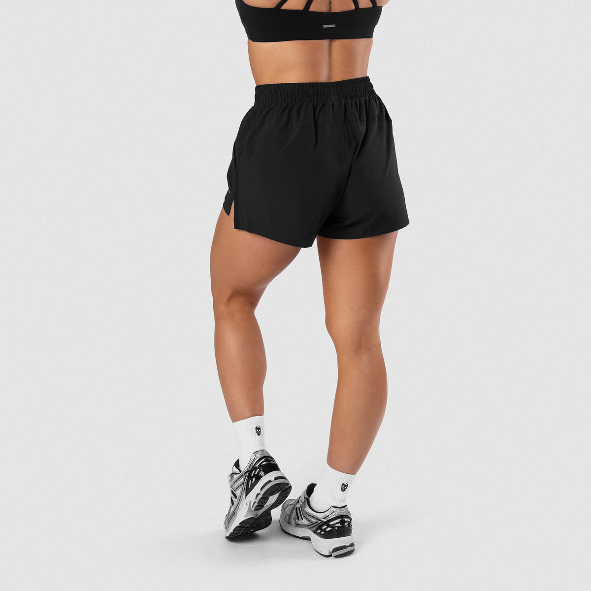 Female model wearing the Axis Sport Shorts - Black side view