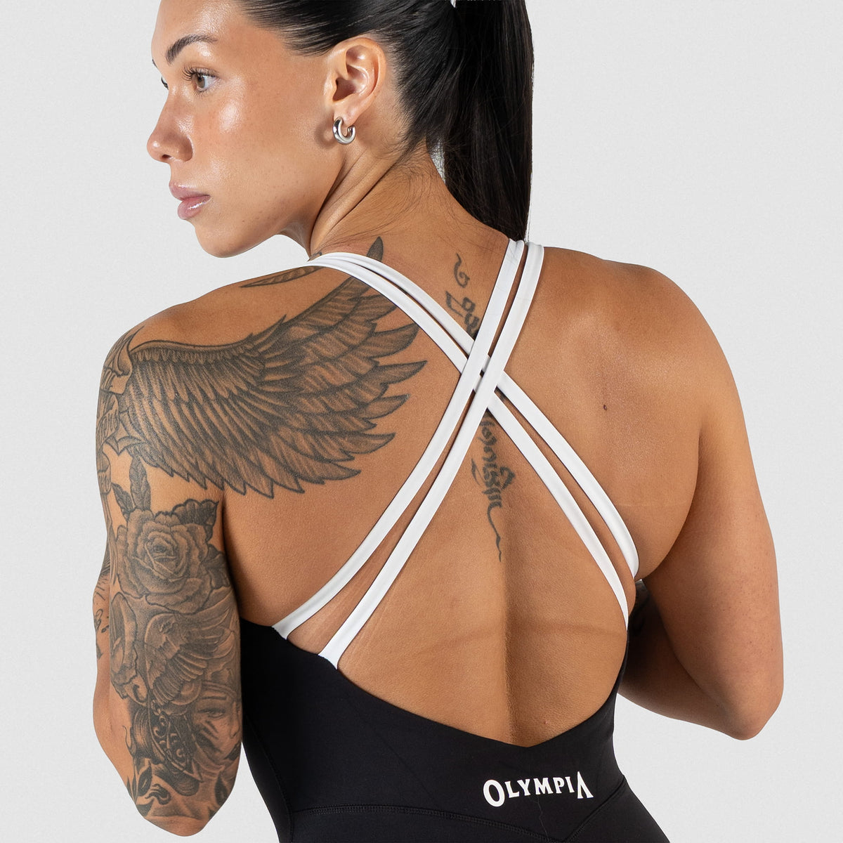 White contrast back criss-cross straps of the Women's Olympia Bodysuit in Black