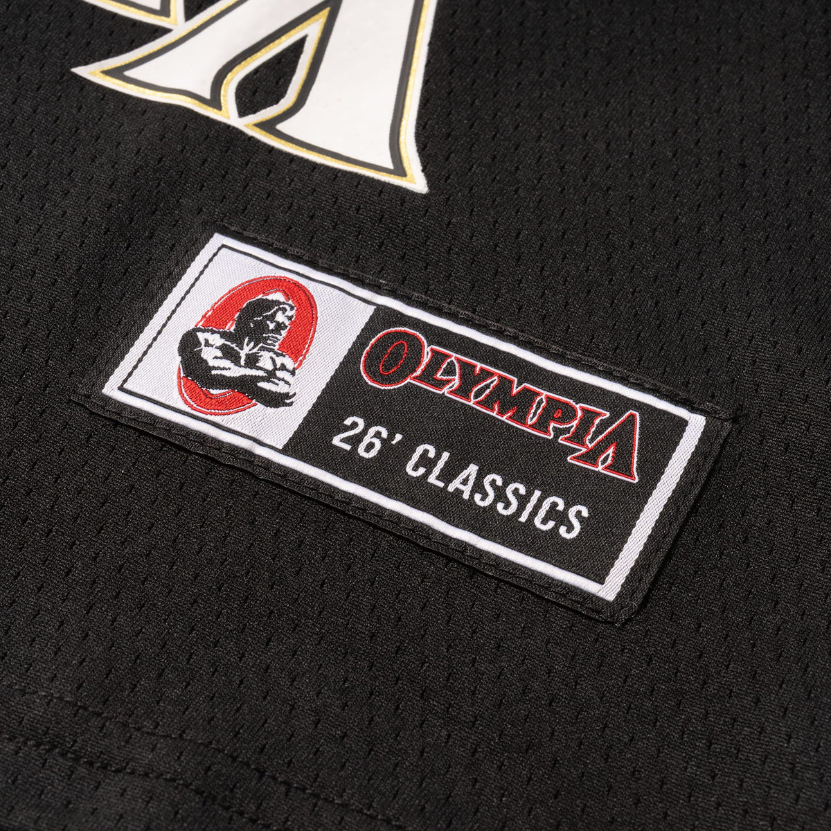 Champions Gold Crop Jersey | Olympia branded jersey tag detailing