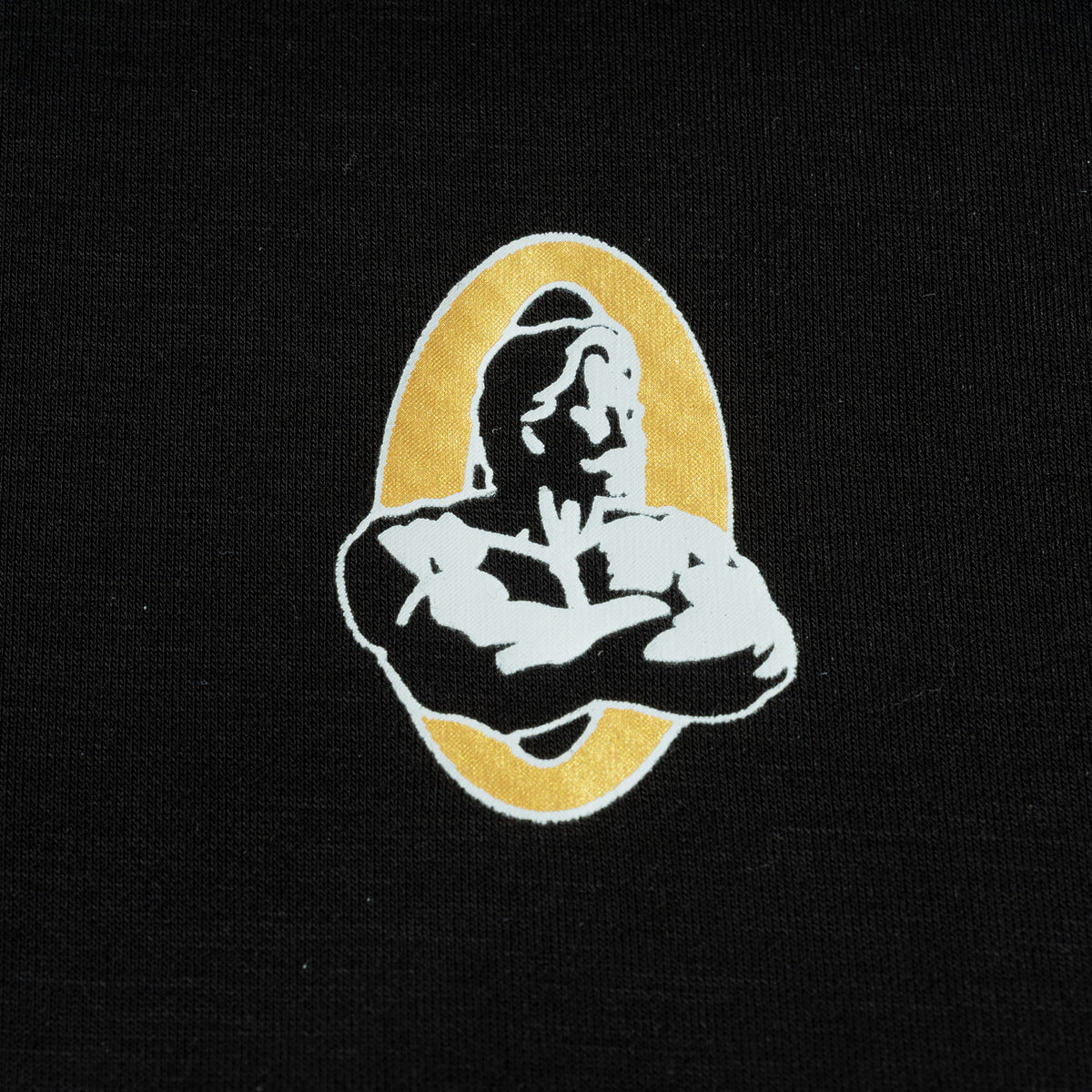 Close up view of the gold and black Champions Gold Olympia logo found on the back of the Champions Gold Full Length Training Tank