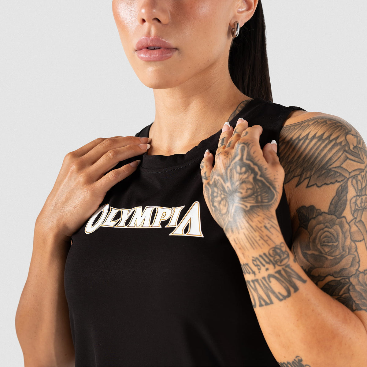 Upper body zoom of the Champions Gold Full Length Training Tank on a female model