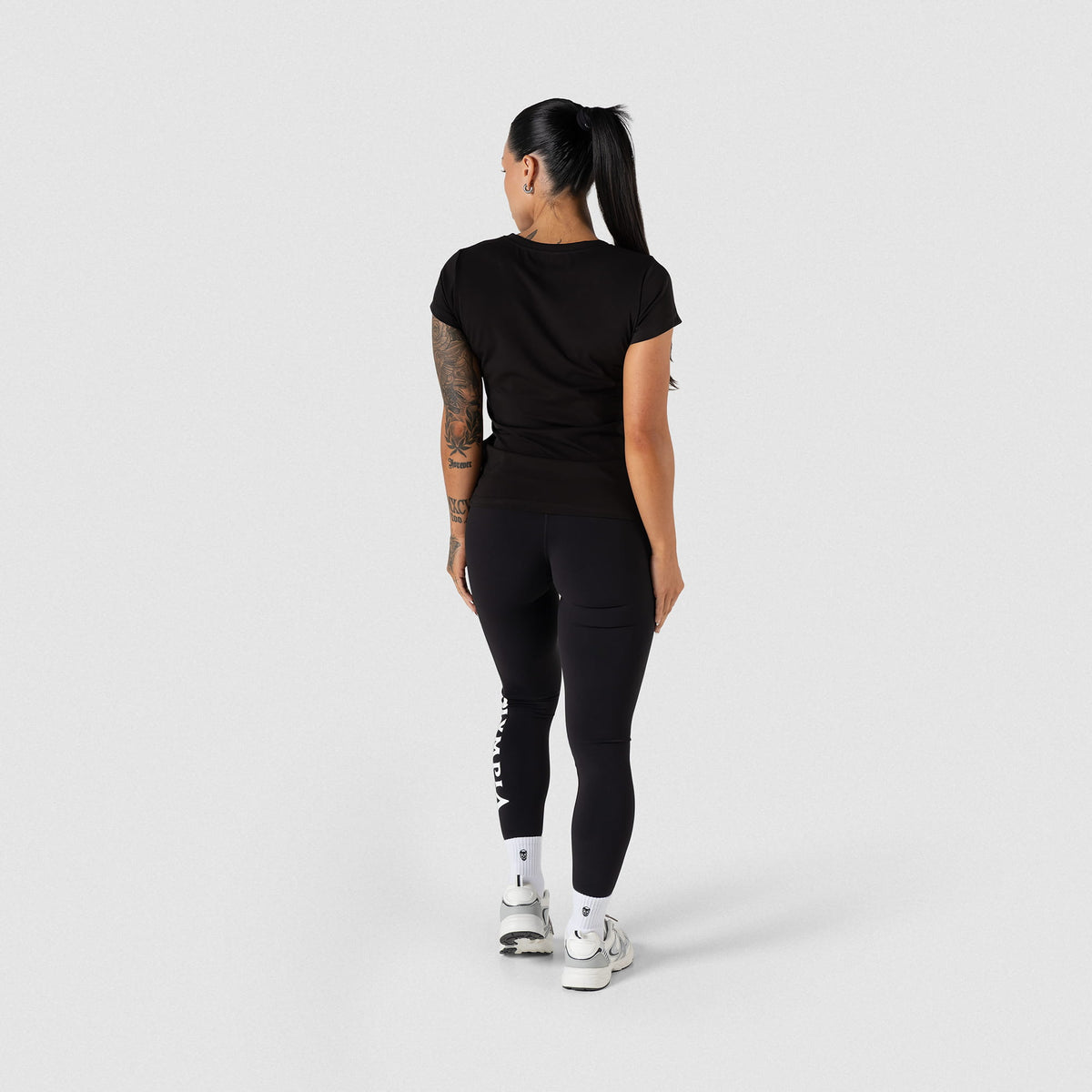 Full body back view of the women's Champions Gold Full Length Training Tee