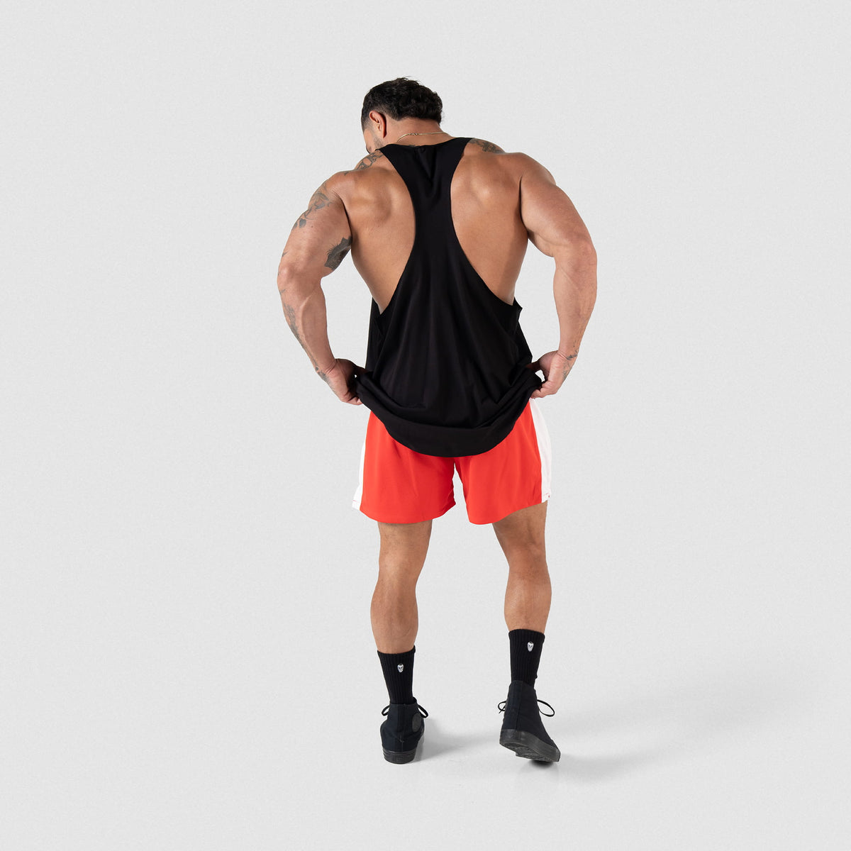 Full body back view of the Olympia International Division Stringer tank top on a male model