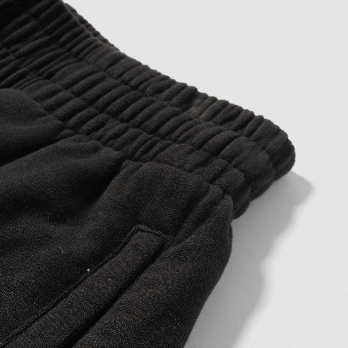 Close up of adjustable waistband and pocket on the women's black Champions Gold Wide-Leg Jogger