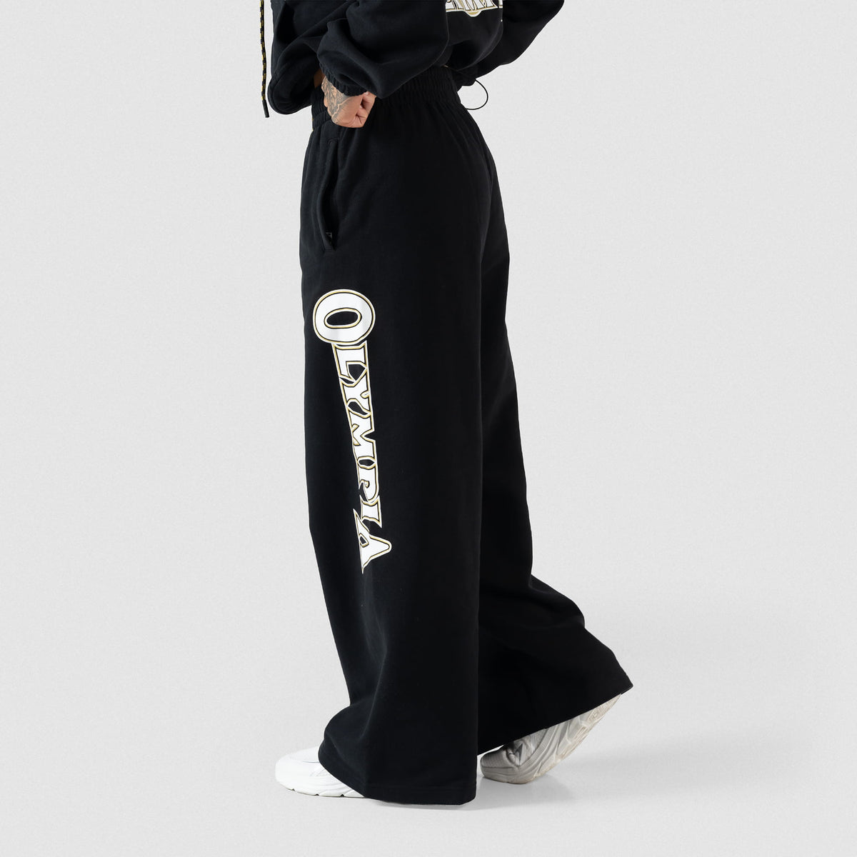 Side model view of the Champions Gold Wide-Leg Jogger in black