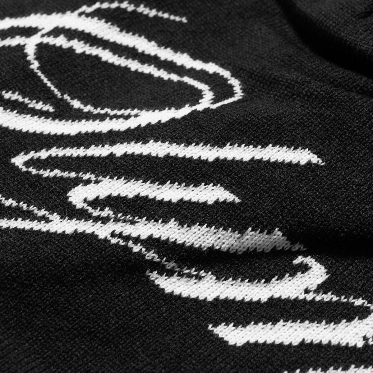 Close up of the white Olympia text on the black Olympia Script Skull Cap