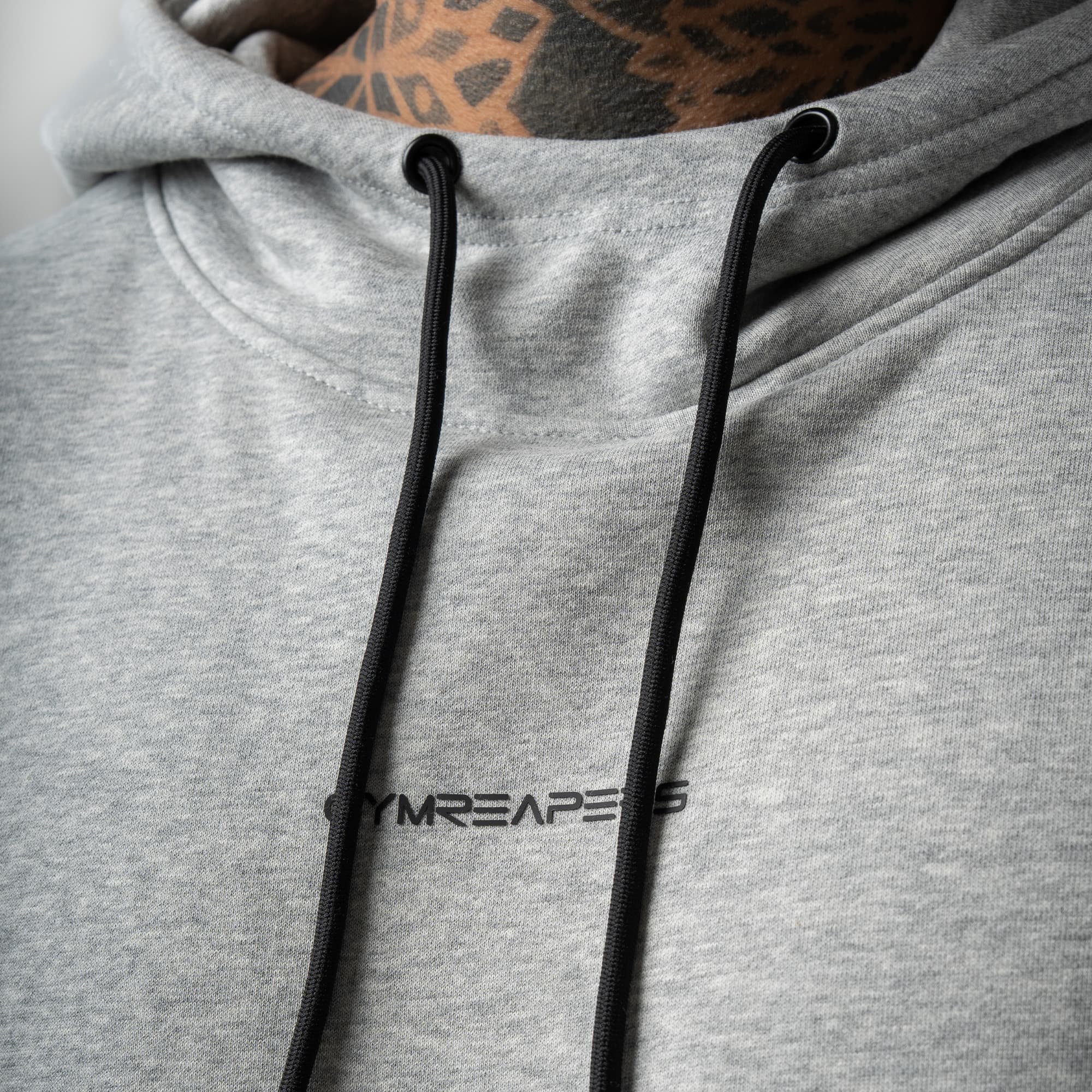 athlete wearing gray axis hoodie close up detail shot of logo