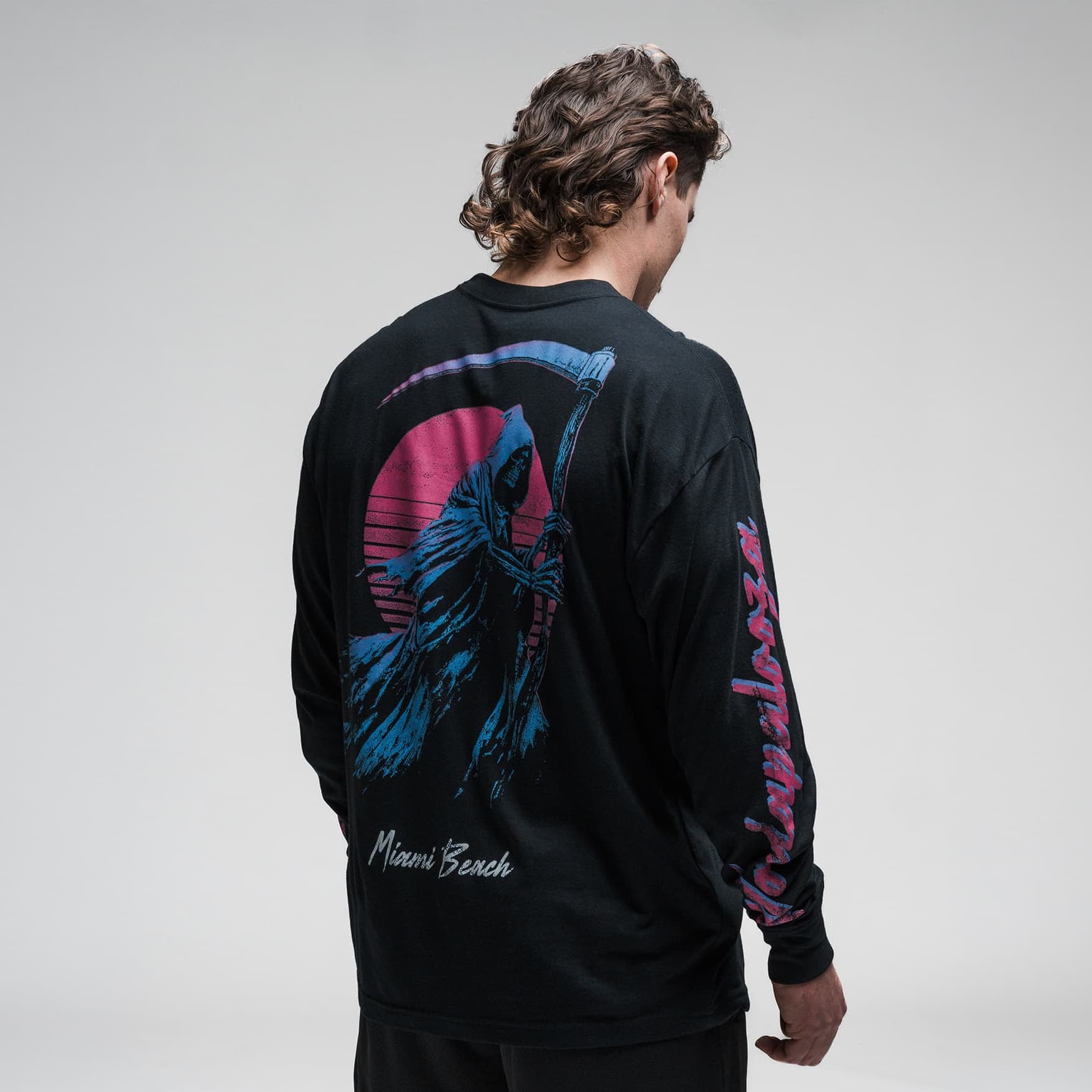 Athlete wearing the Moon Breaker Long Sleeve Shirt half body shot back side