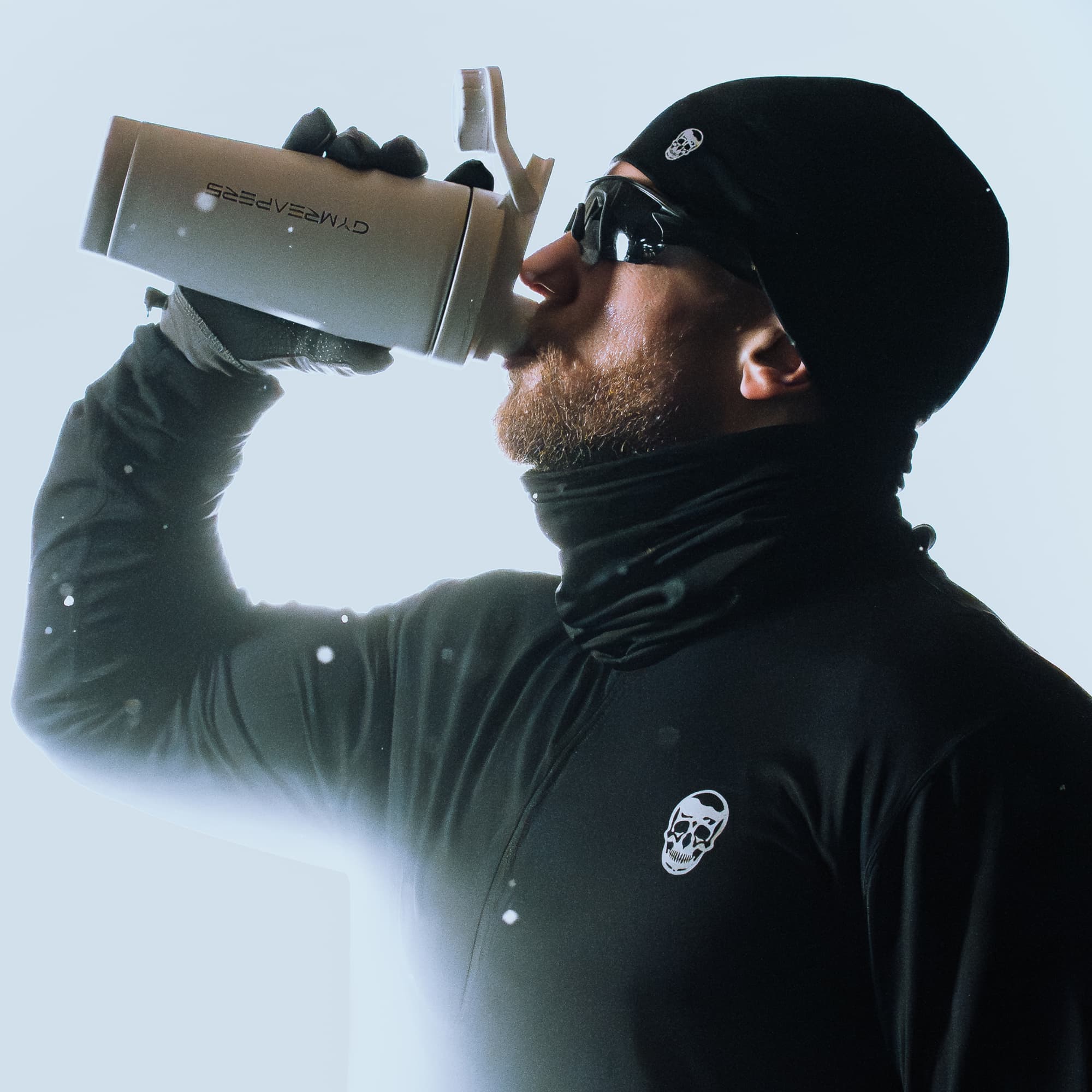 Lifestyle shot of athlete wearing the Stryda™ Snood drinking water