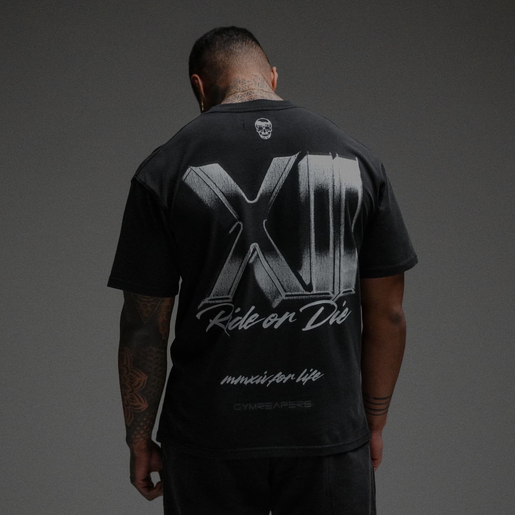 Athlete wearing 12th Anniversary Tee - Ride or Die half body shot back side
