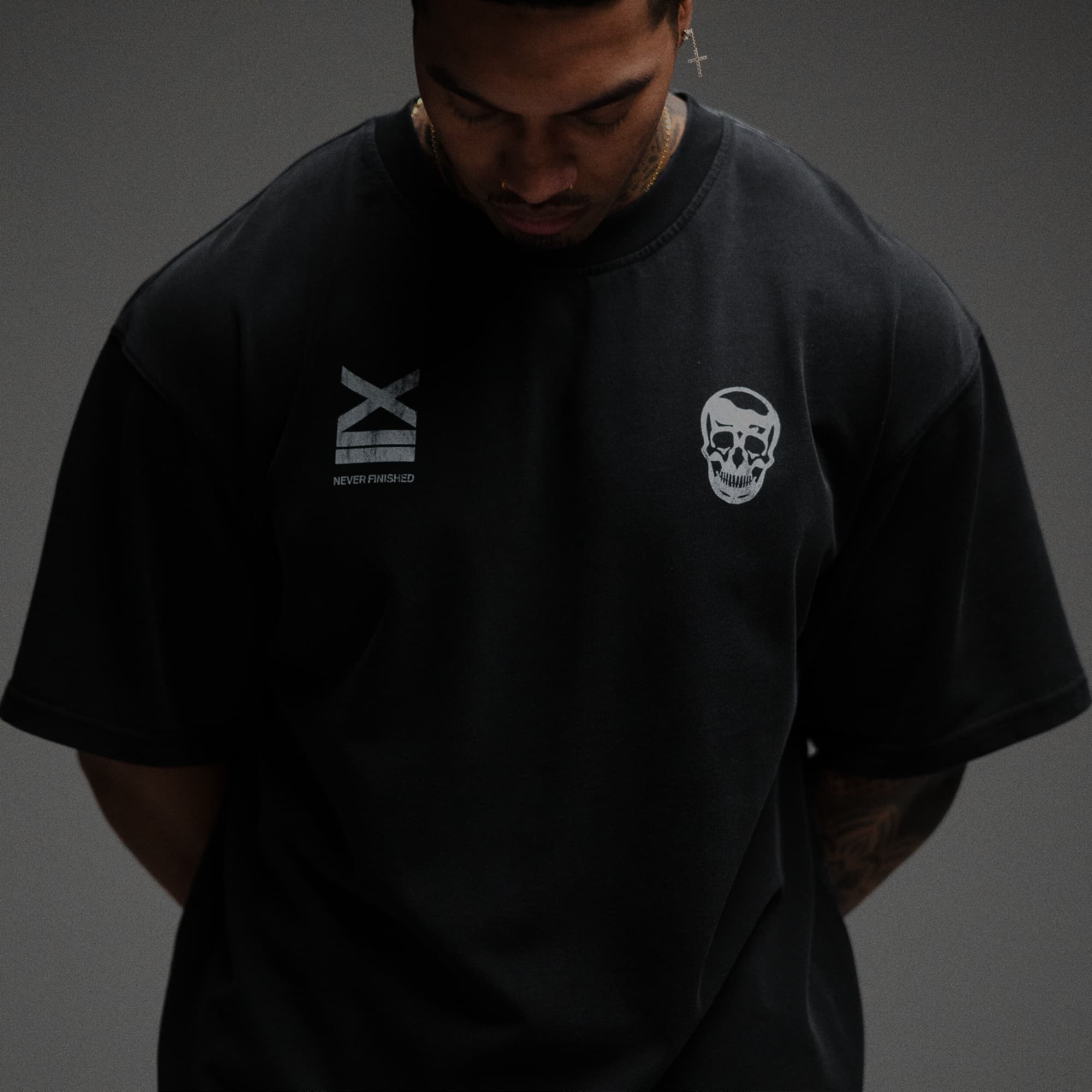 Athlete wearing 12th Anniversary Tee - Never Finished close up shot of front graphic