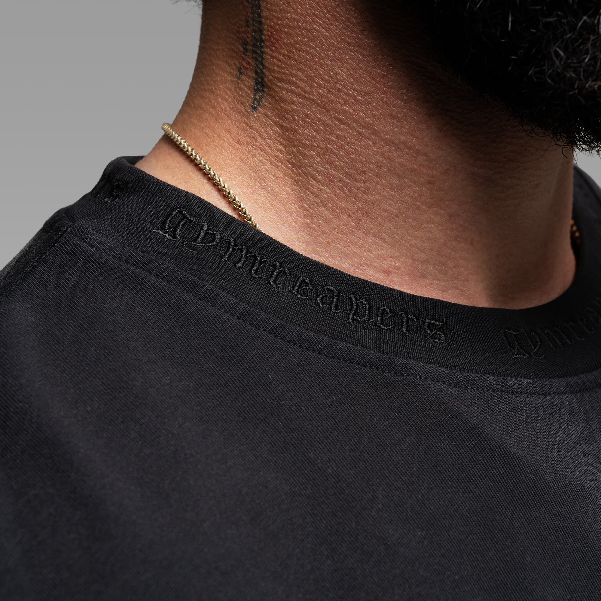 Athlete wearing the Standard Tee close up shot of neckline logo