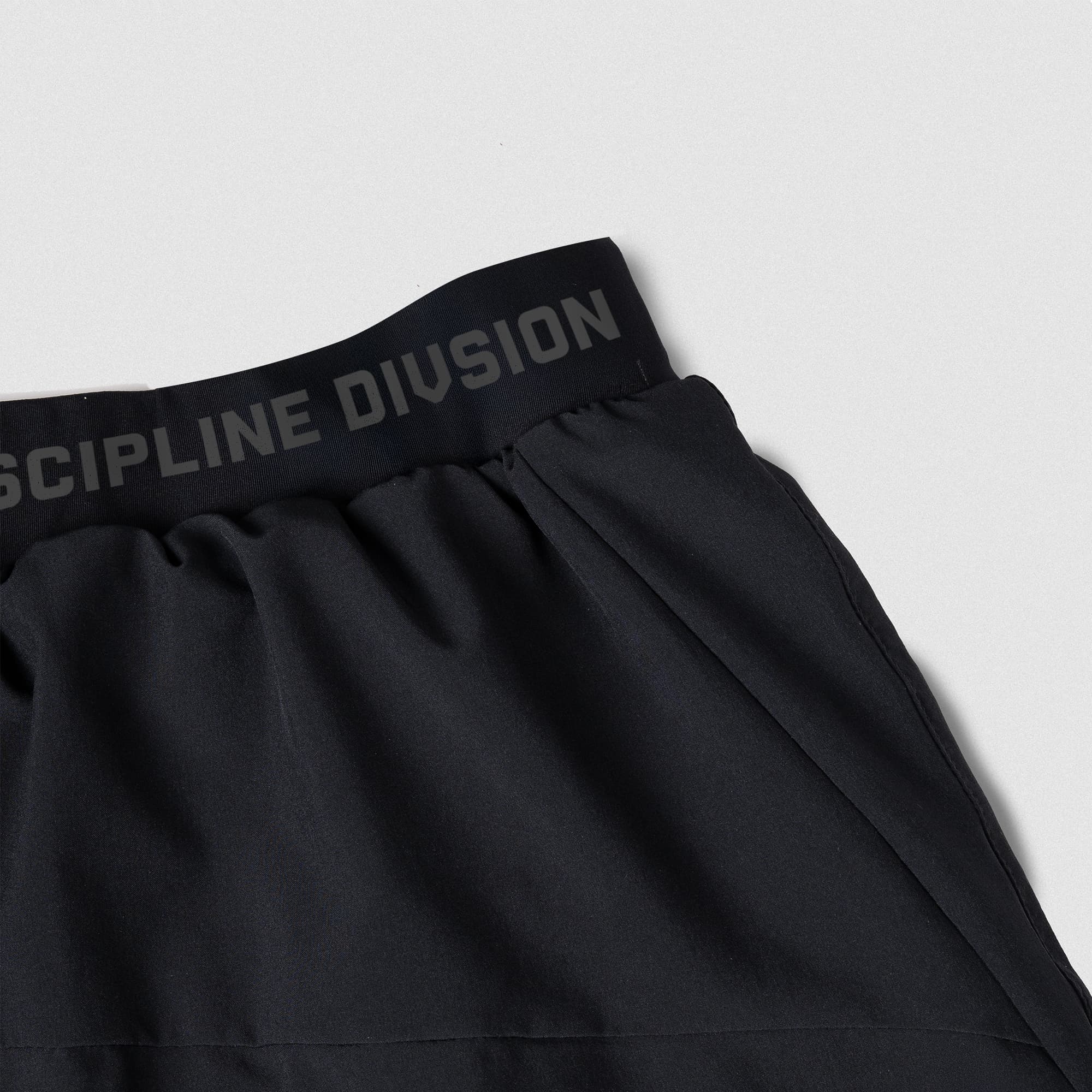 discipline division running shorts lay flat close up shot of waistband logo