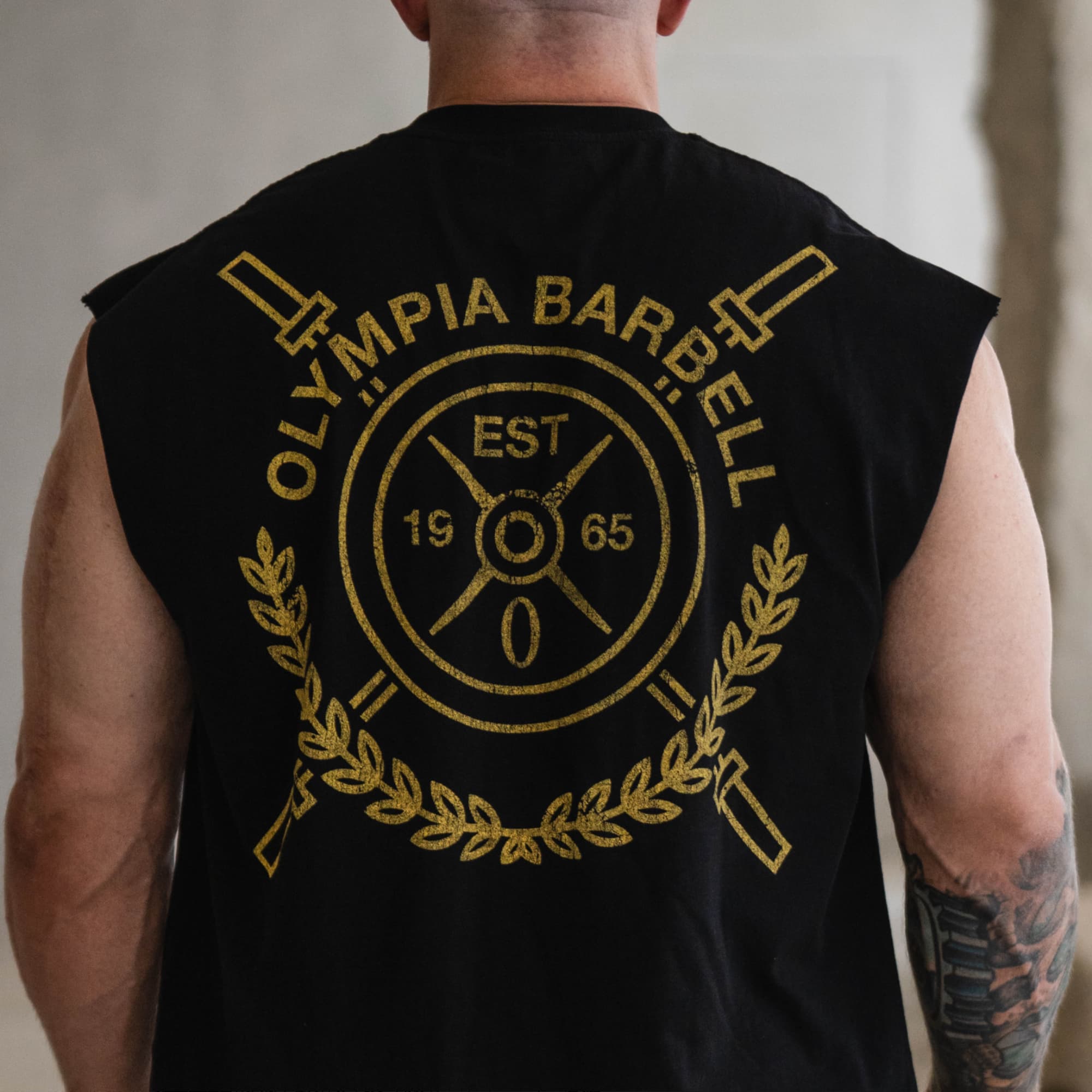 Close-up of the back gold crest graphic on the Olympia Crest Cut Off