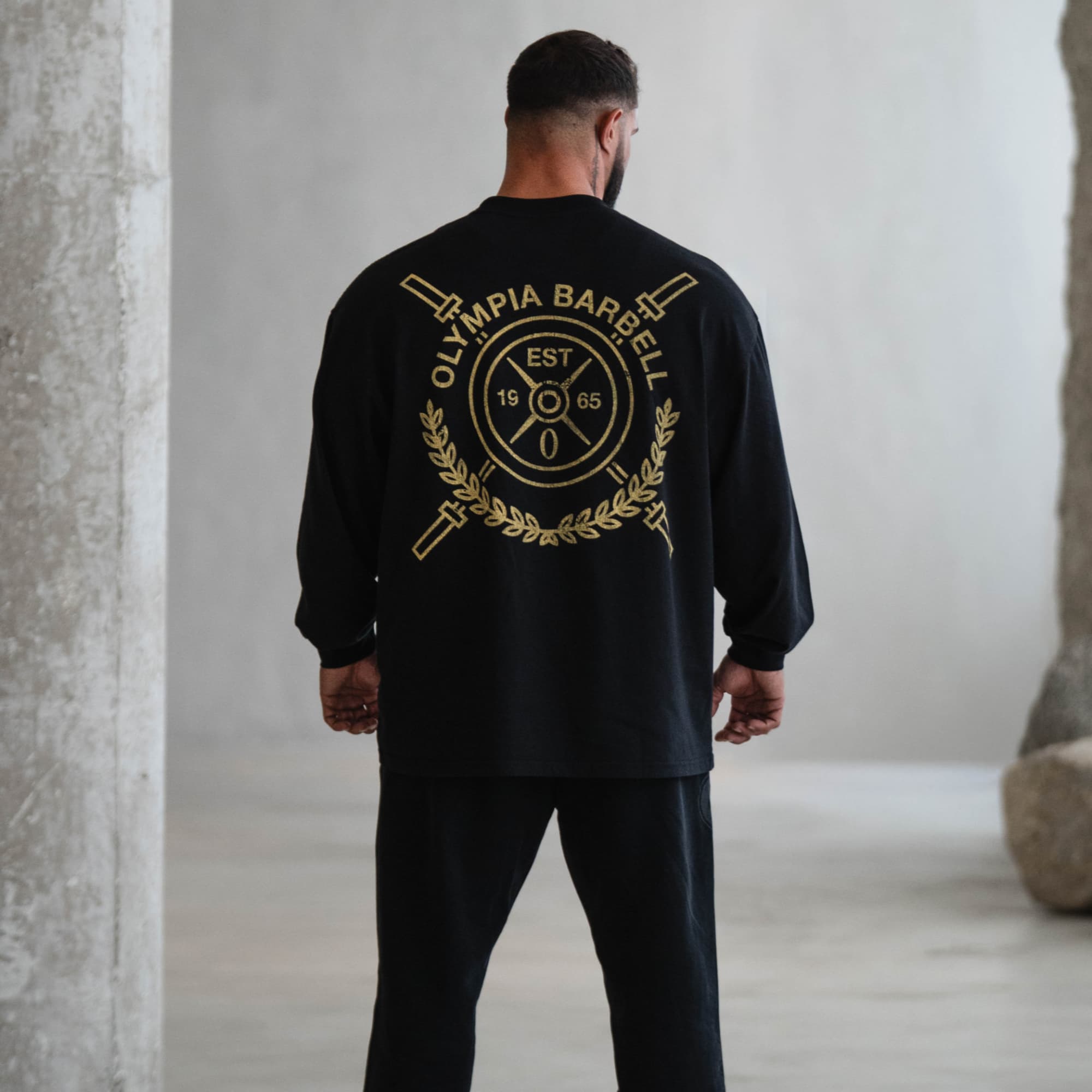 lifestyle shot of athlete wearing the crest long sleeve shirt showcasing back graphic