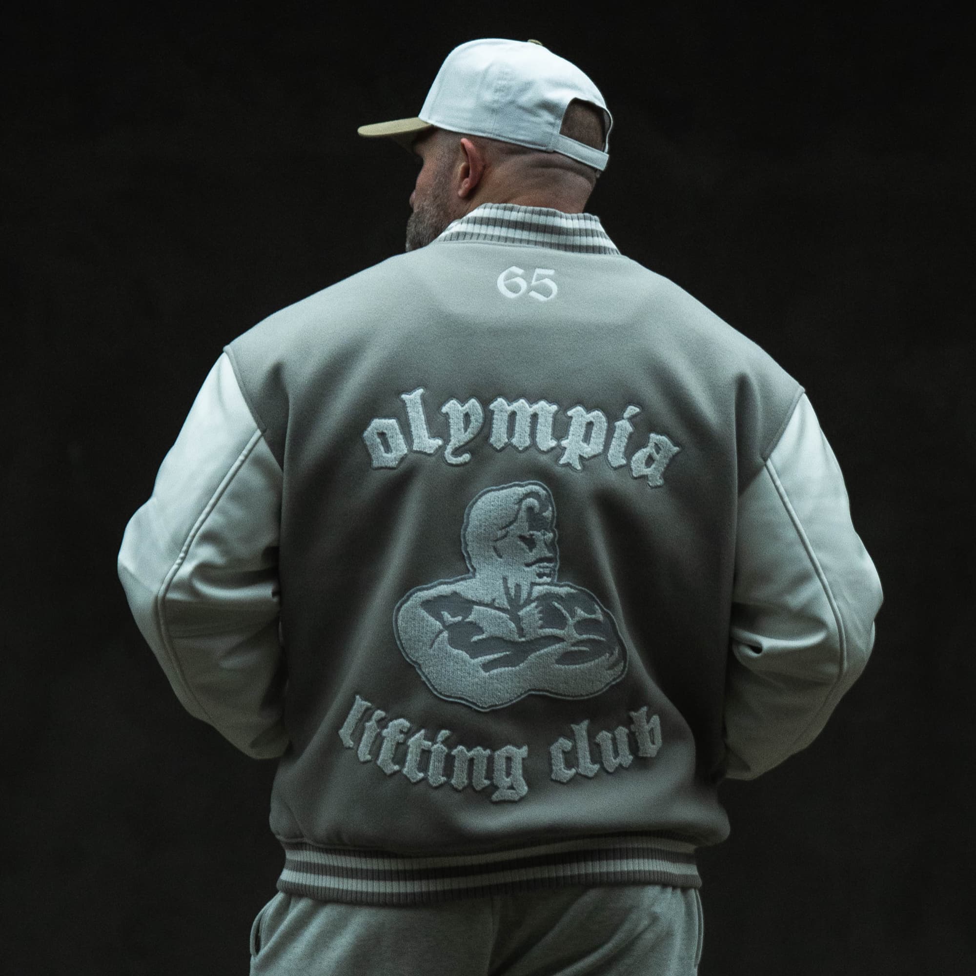 Olympia Lifting Club Varsity Jacket on athlete showing back side