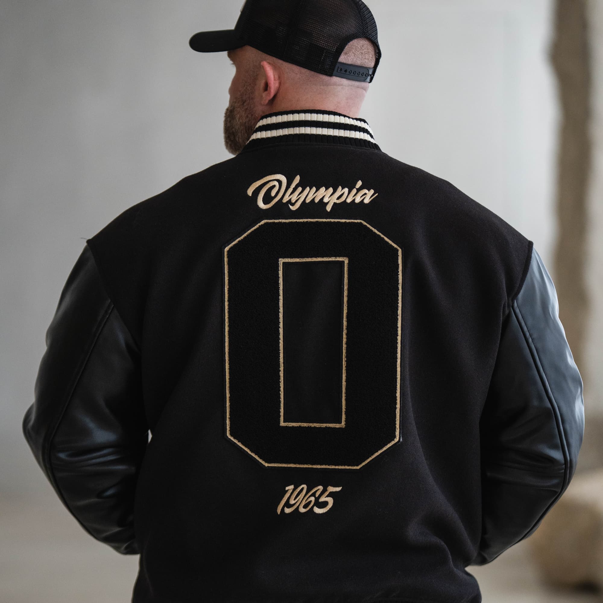 Olympia O Varsity Jacket on athlete close up shot of back graphic
