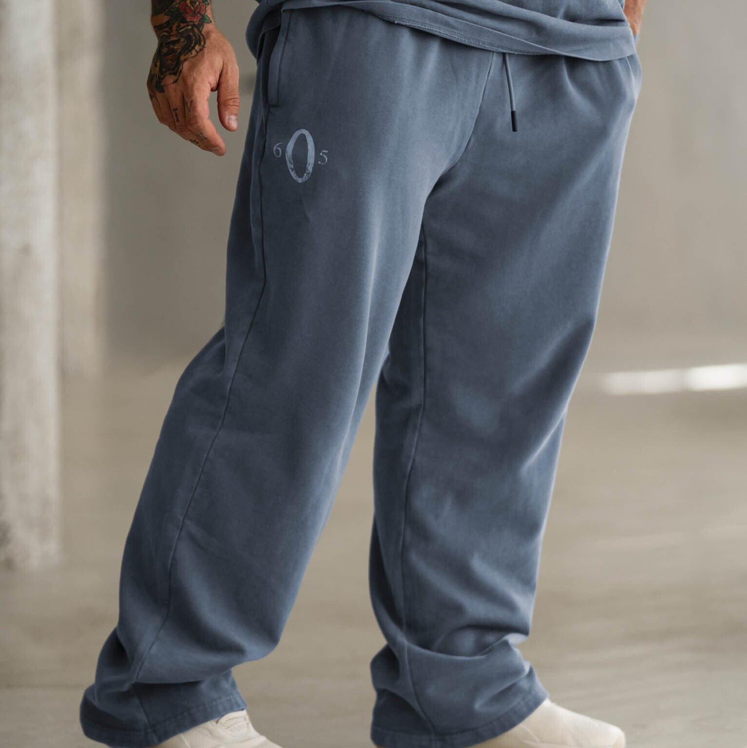 Side view of model wearing pale blue Olympia wreath joggers
