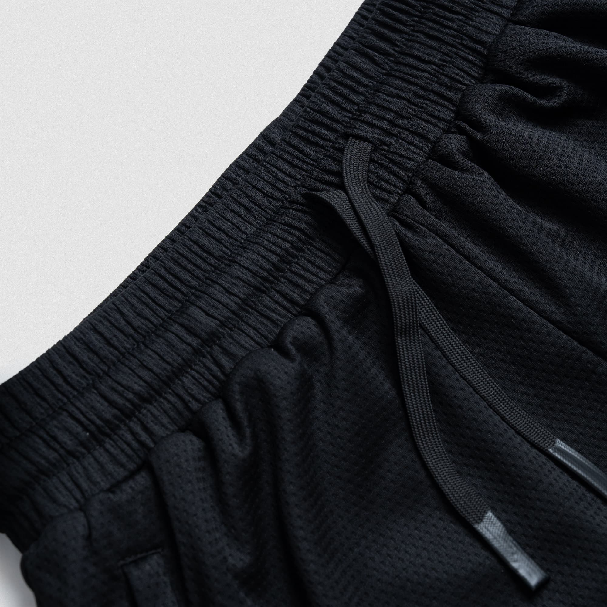 Close-up waistband and drawstring detail of Olympia O Mesh Shorts showing elastic stretch and breathable mesh fabric