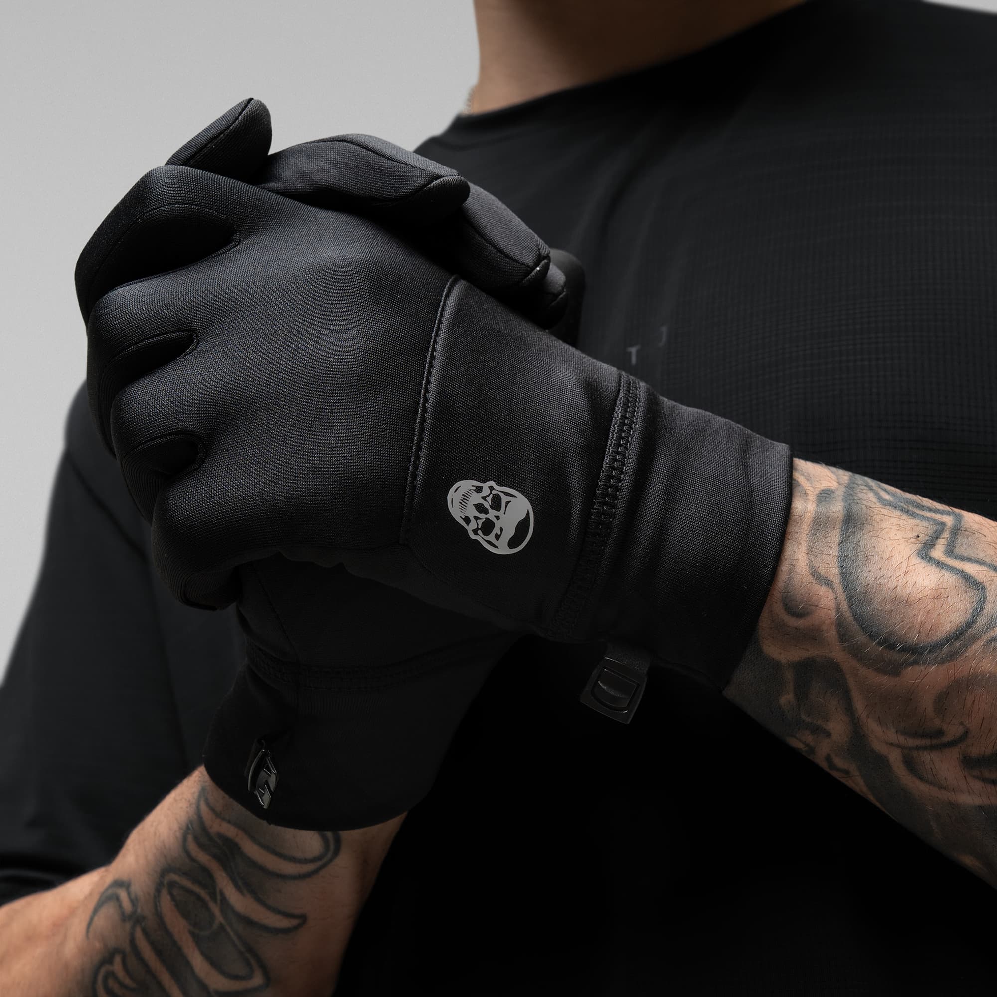 Model wearing the Black Stryda™ Run Gloves showcasing logo