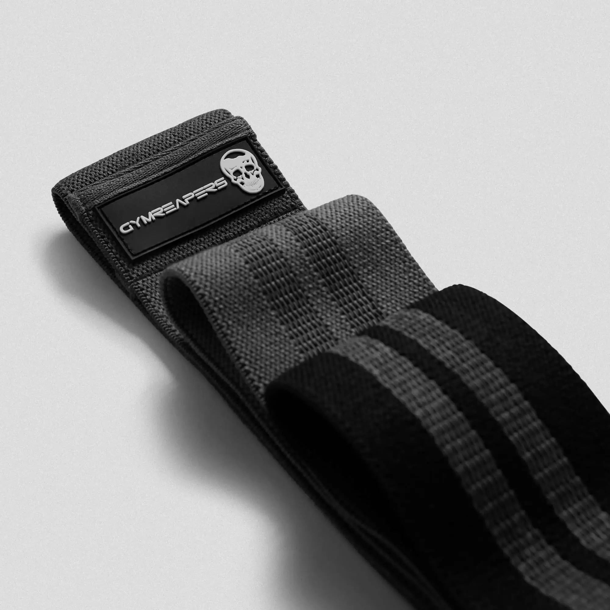 close up shot of black hip bands stacked on gray background
