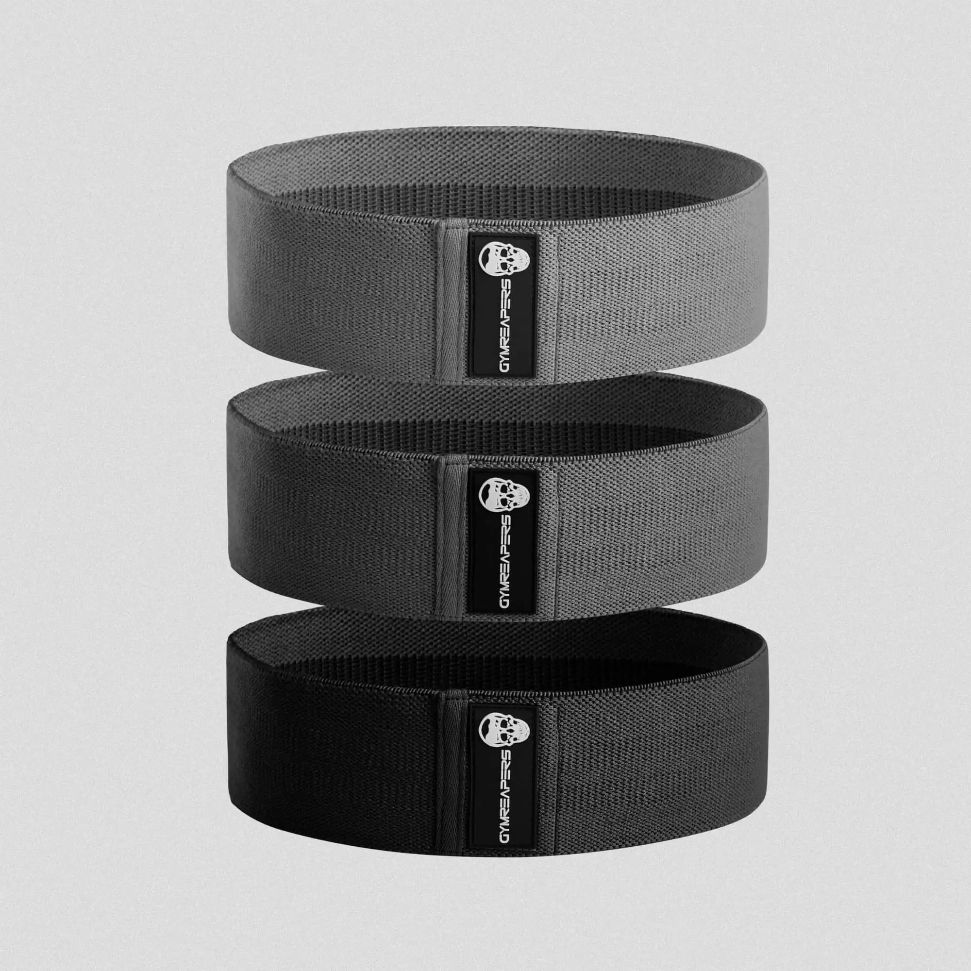 Photo of black hip bands stacked on gray background