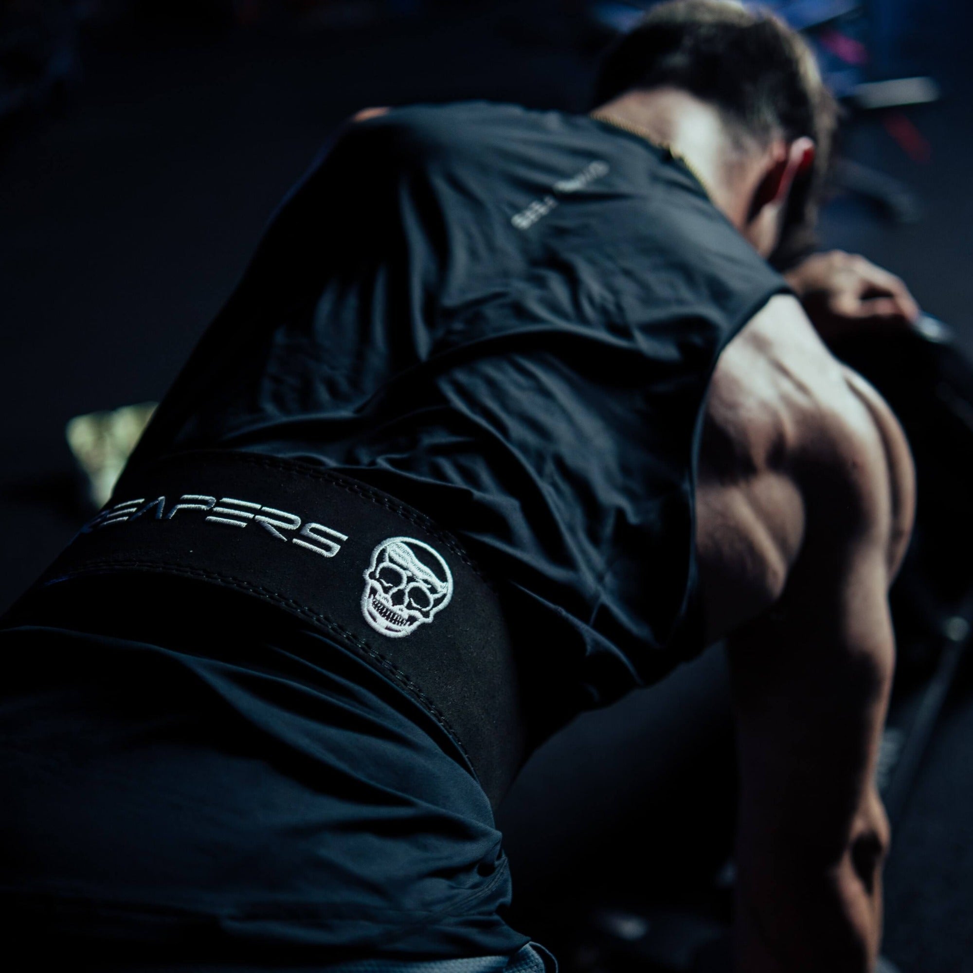 bent over rows with back of black white lever belt in use showing off logo