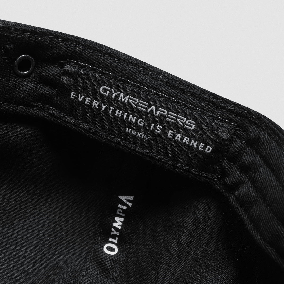 Inside tag of the Champions Gold 5-Panel Hat with GYMREAPERS Everything Earned MMXIV text