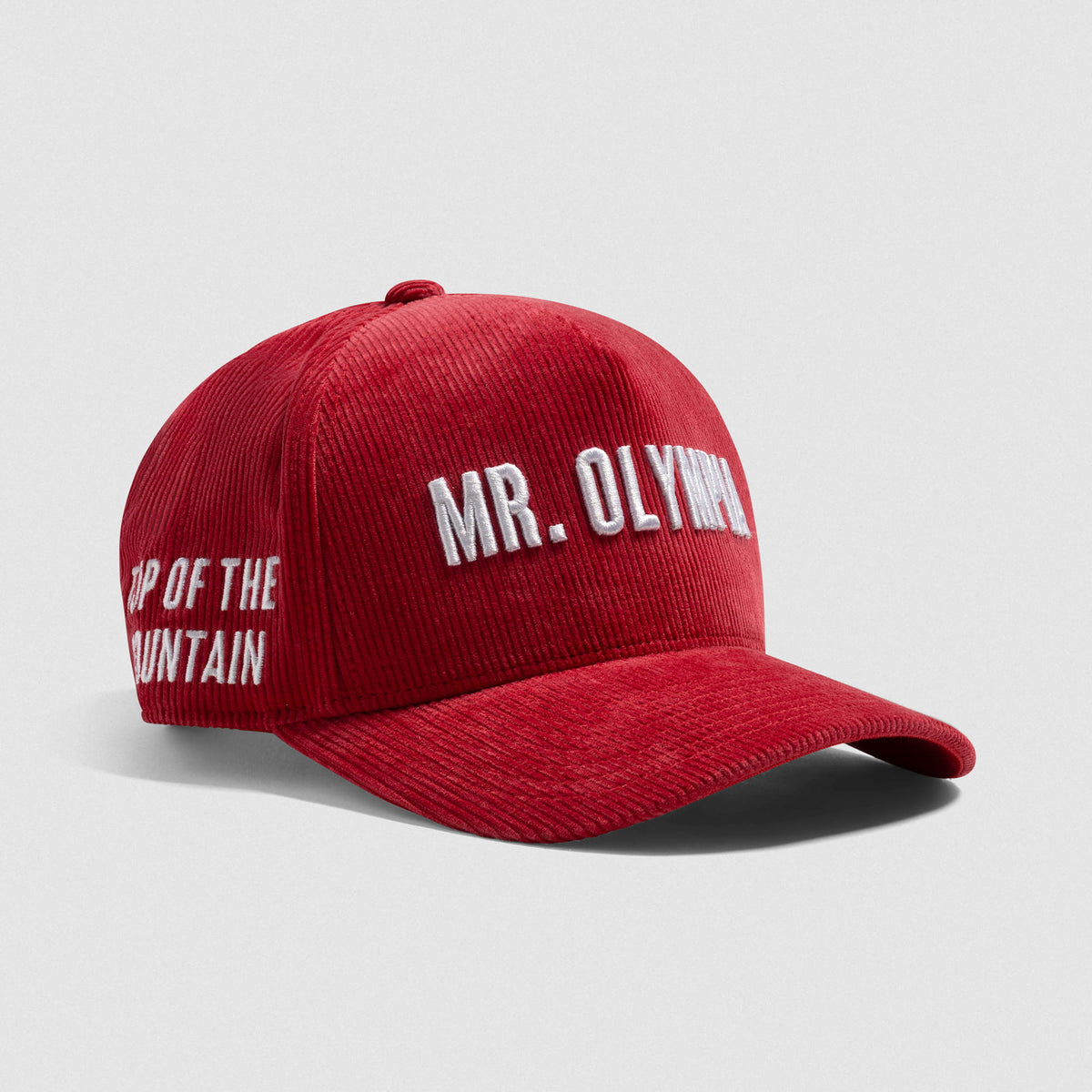 Front angle view of the Mr. Olympia Corduroy 5-Panel Hat that displays the Mr. Olympia wordmark above the bill and Top of the Mountain text on the side