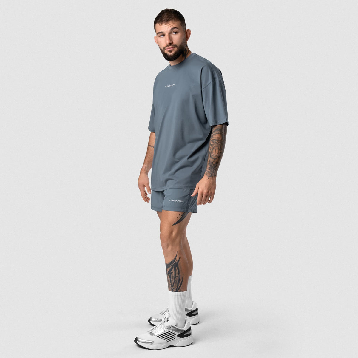 Male model wearing the Axis Box Tee - Lake full-body view