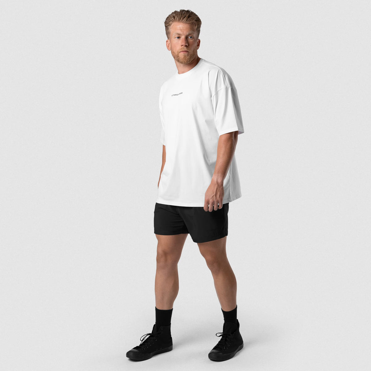 Male model wearing the Axis Box Tee - White full-body view