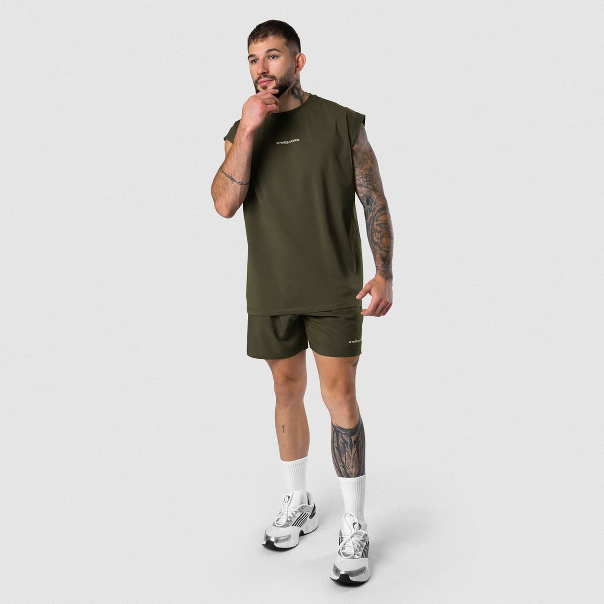 Male model wearing the Axis Cap Sleeve Tank - OD Green full-body view