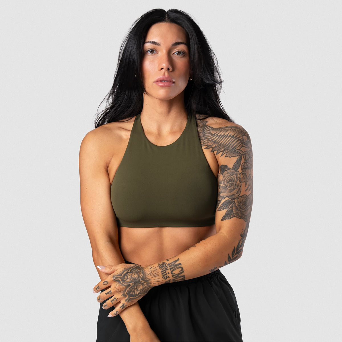 Female model wearing the Axis High Neck Bra - OD Green front view