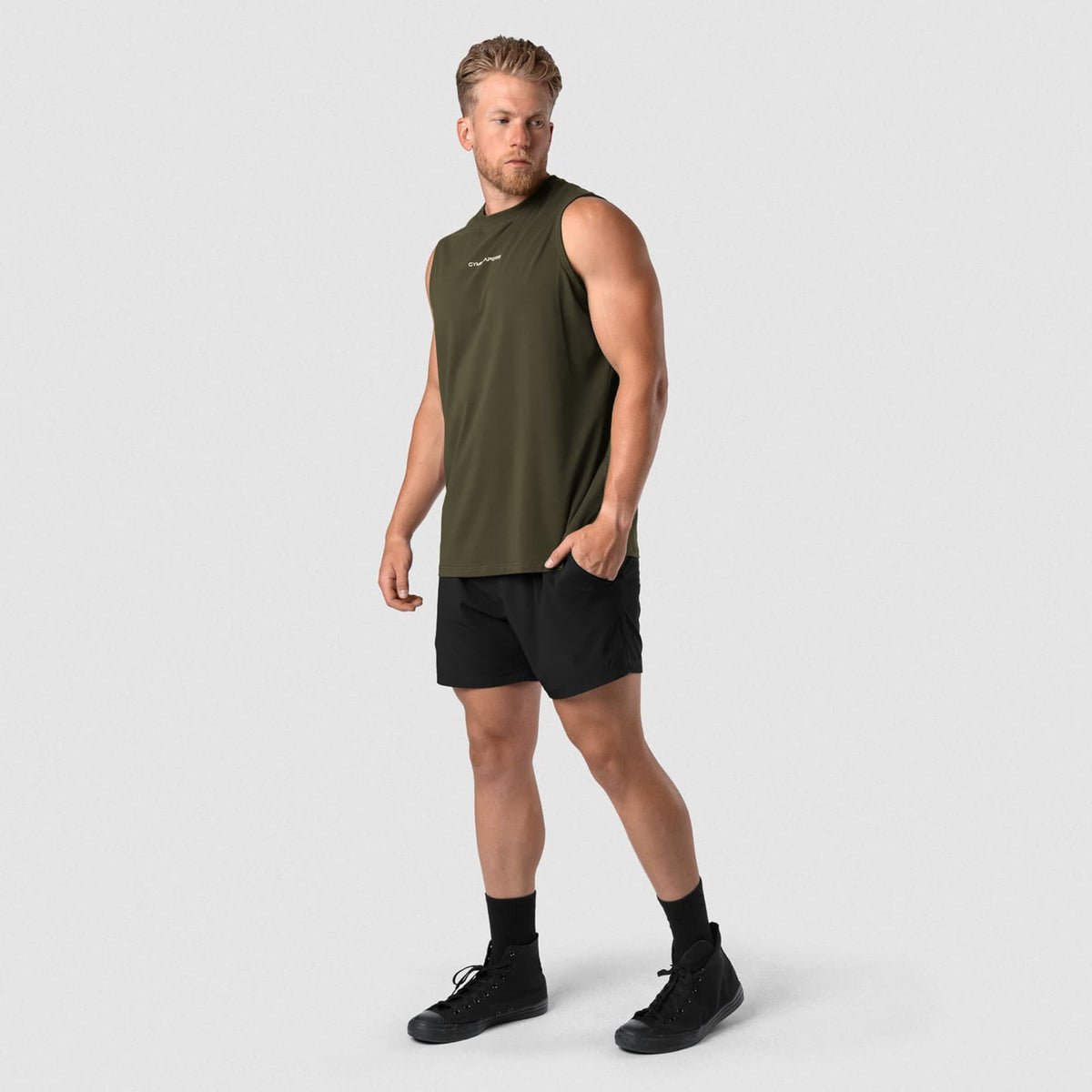 Male model wearing the Axis Muscle Tank - OD Green full-body view