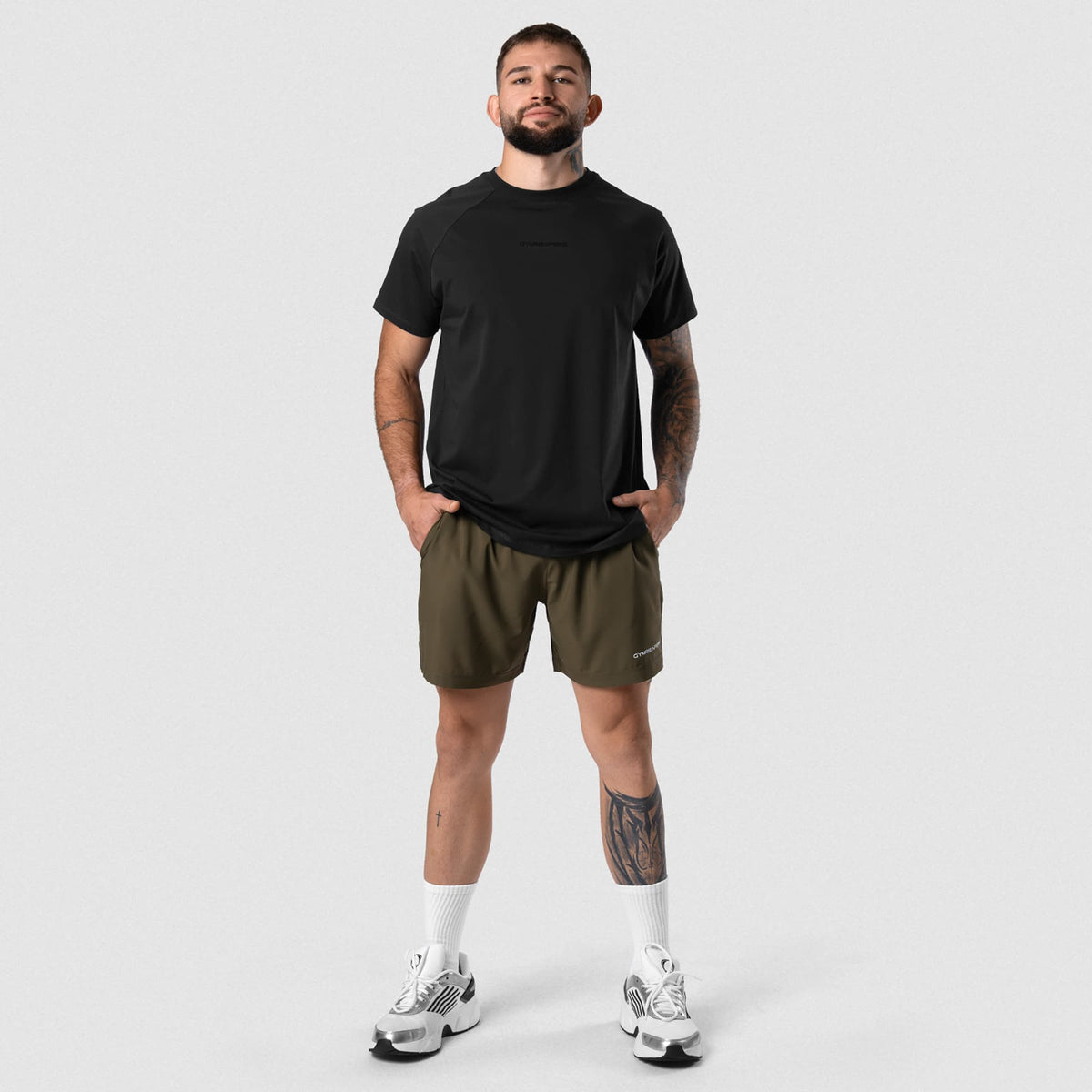 Male model wearing the Axis Raglan Tee - Black/Black full-body view