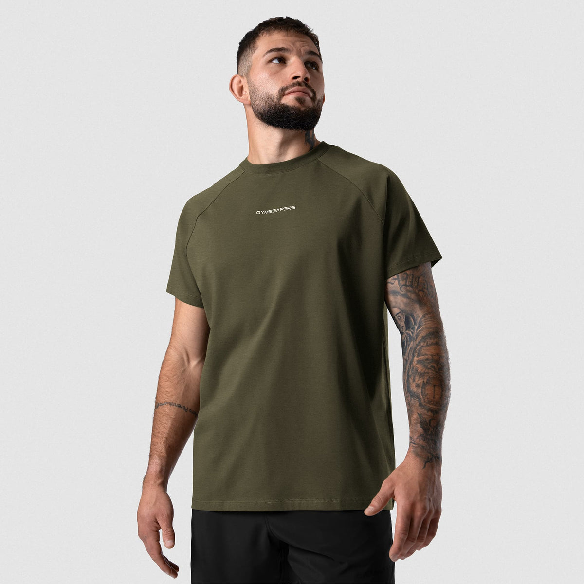 Male model wearing the Axis Raglan Tee - OD Green front view