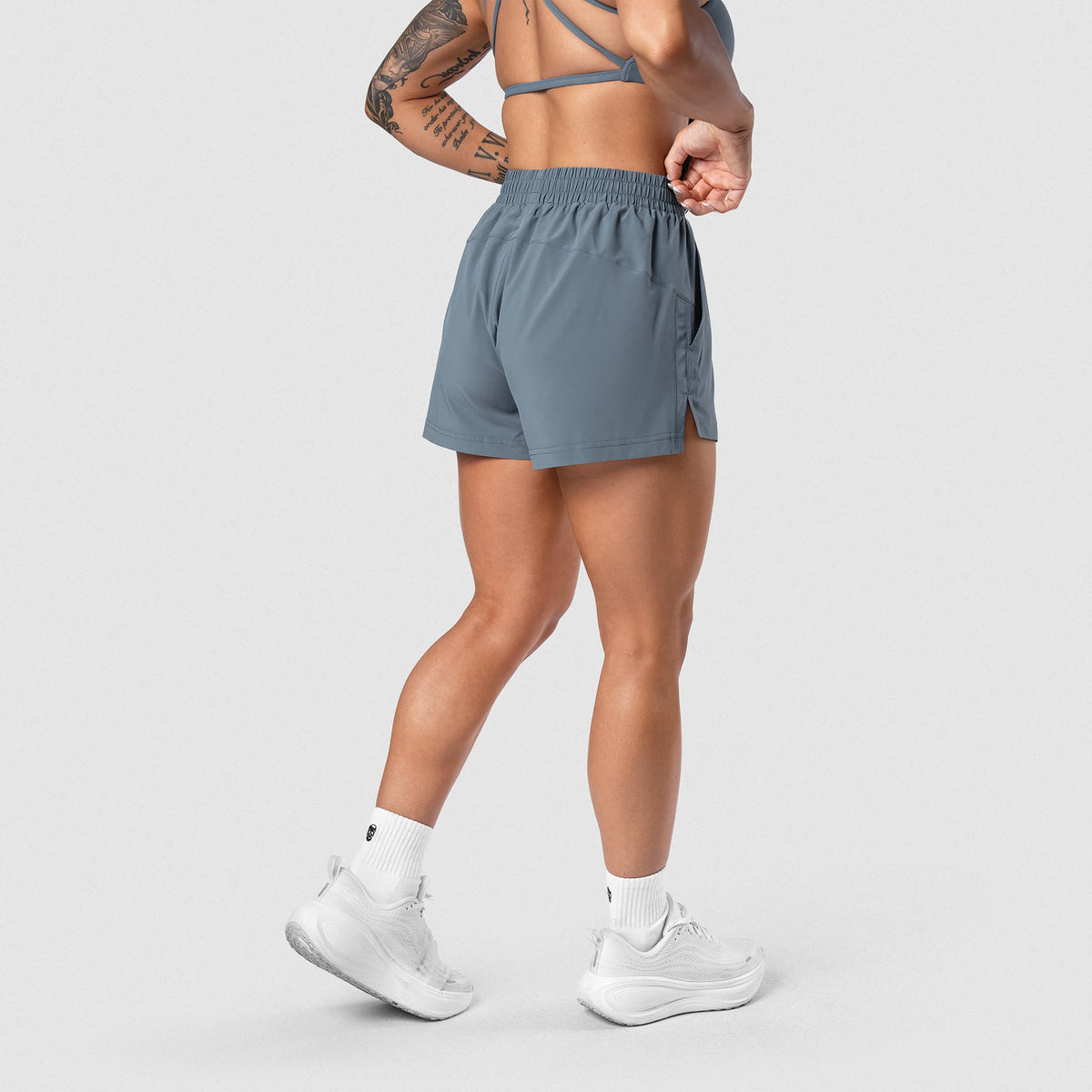 Female model wearing the Axis Sport Shorts - Lake side view