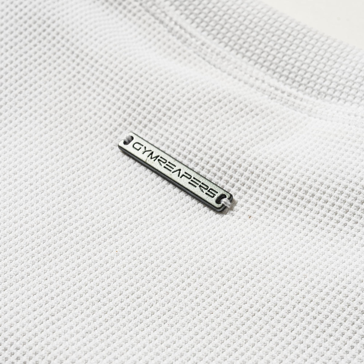 Axis Support Baby Tee - White metal Gymreapers logo bar detail