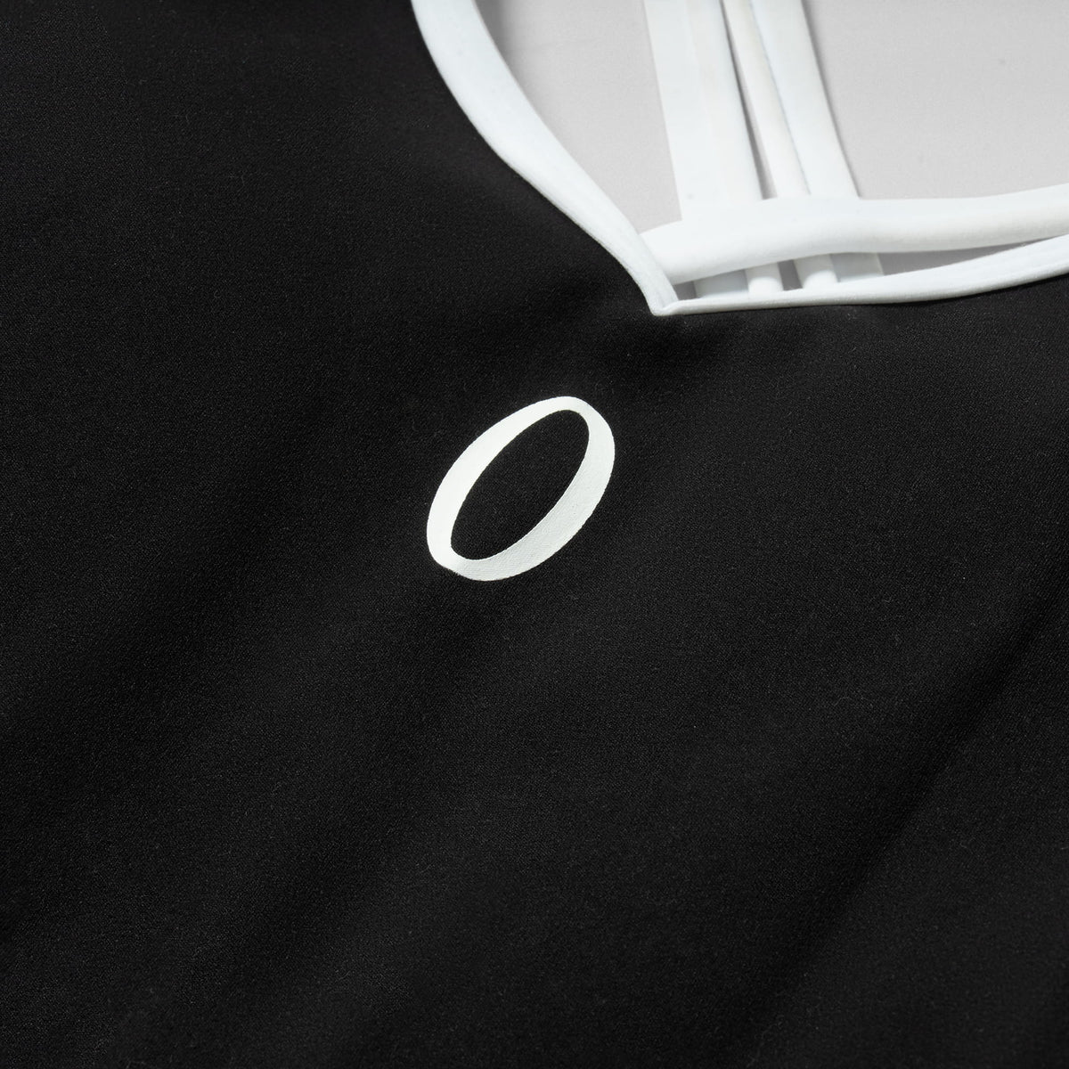 "O" logo on the chest of the Olympia Bodysuit