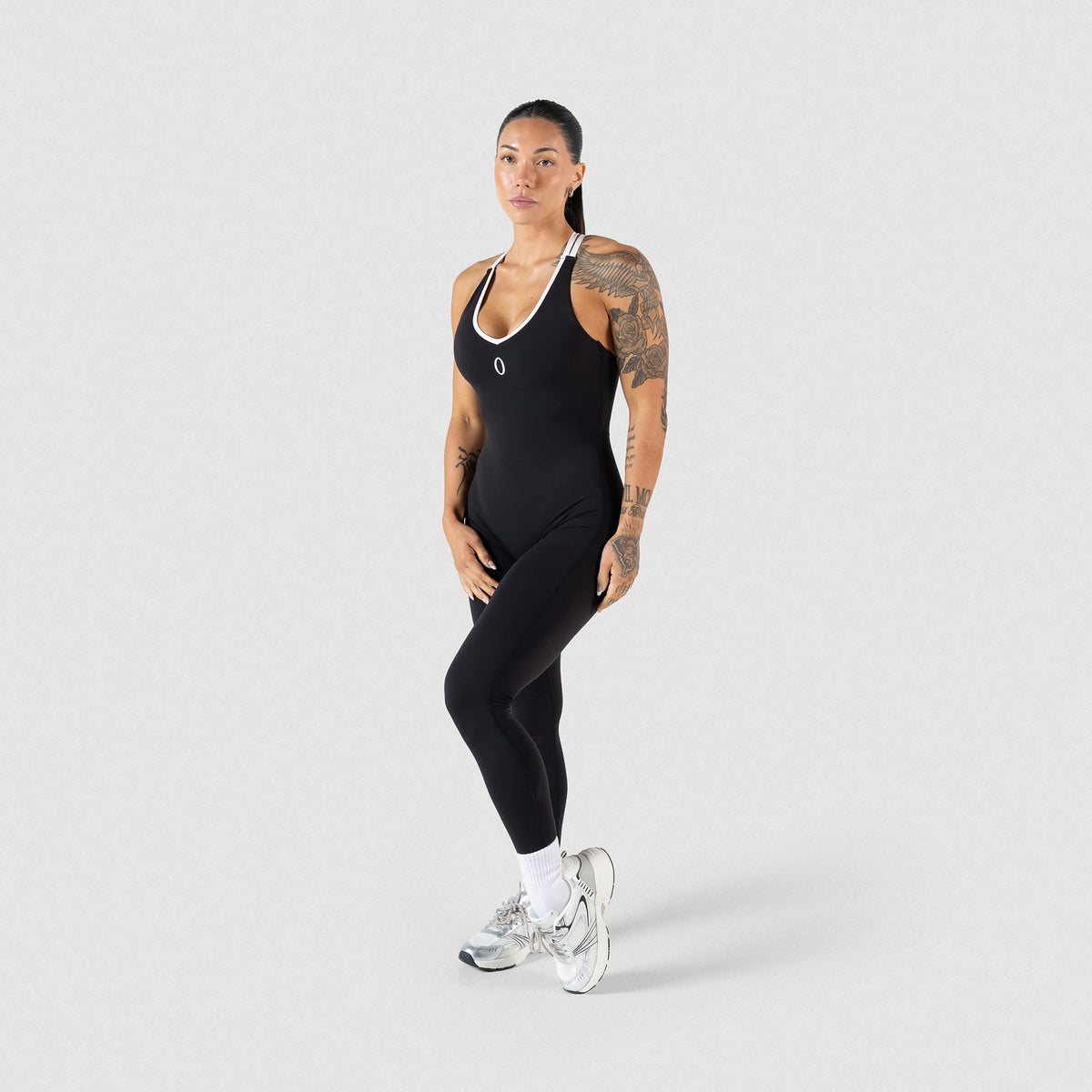 Full body view of model wearing the black and white contrast Olympia Bodysuit
