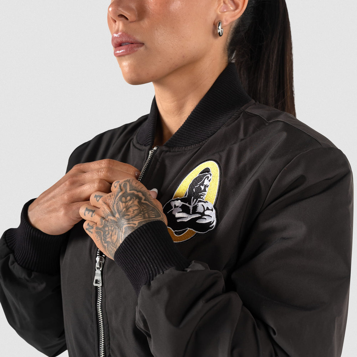 Champions Gold Crop Bomber Jacket | Model wearing half zipped jacket