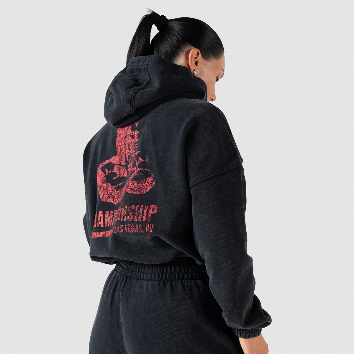Championship Crop Hoodie | On model, back view of large Championship, Olympia Las Vegas event logo
