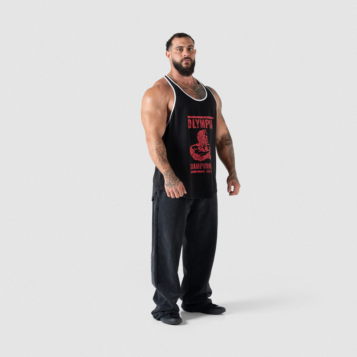 Full body view of Championship Stringer paired with black sweatpants