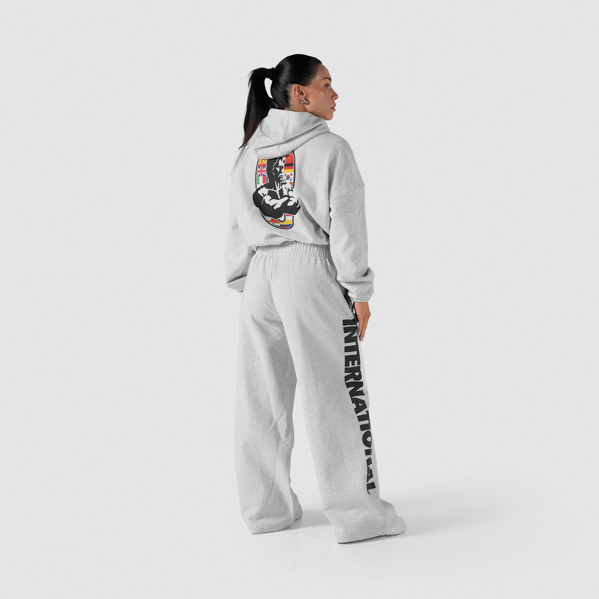 International Division Crop Hoodie | Full body back view of gray pullover hoodie and matching gray joggers