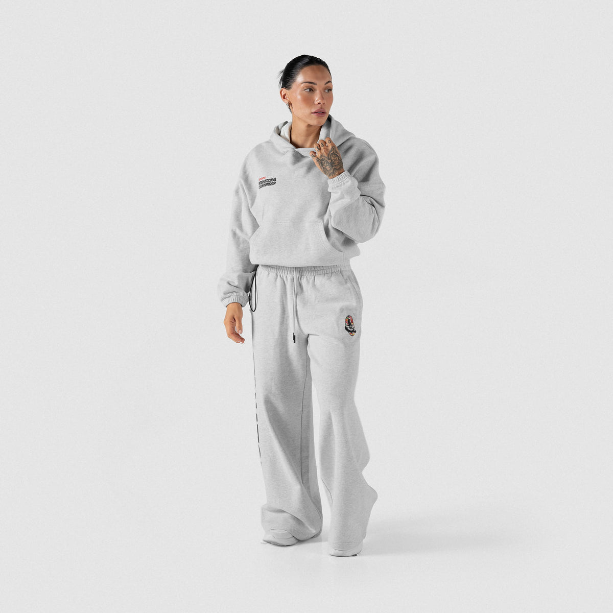 International Division Crop Hoodie | Full body model view of gray pullover hoodie and matching joggers