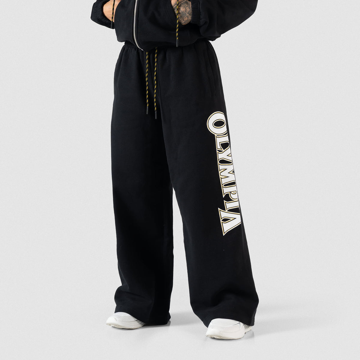 Front model view of the Champions Gold Wide-Leg Jogger in Black